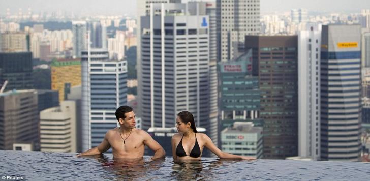 Just enjoying the sun: Models pose in the pool for journalists at the grand opening yesterda